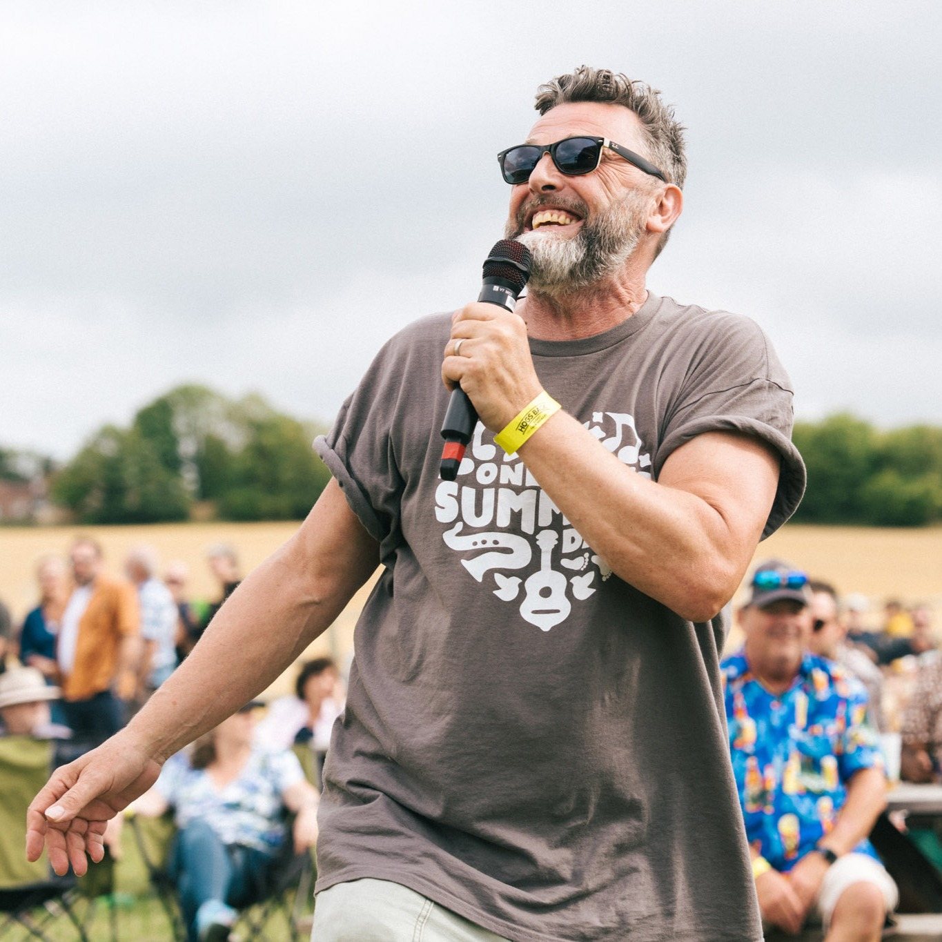 Festival MC with microphone at One Summer's Day, Hogs Back Brewery
